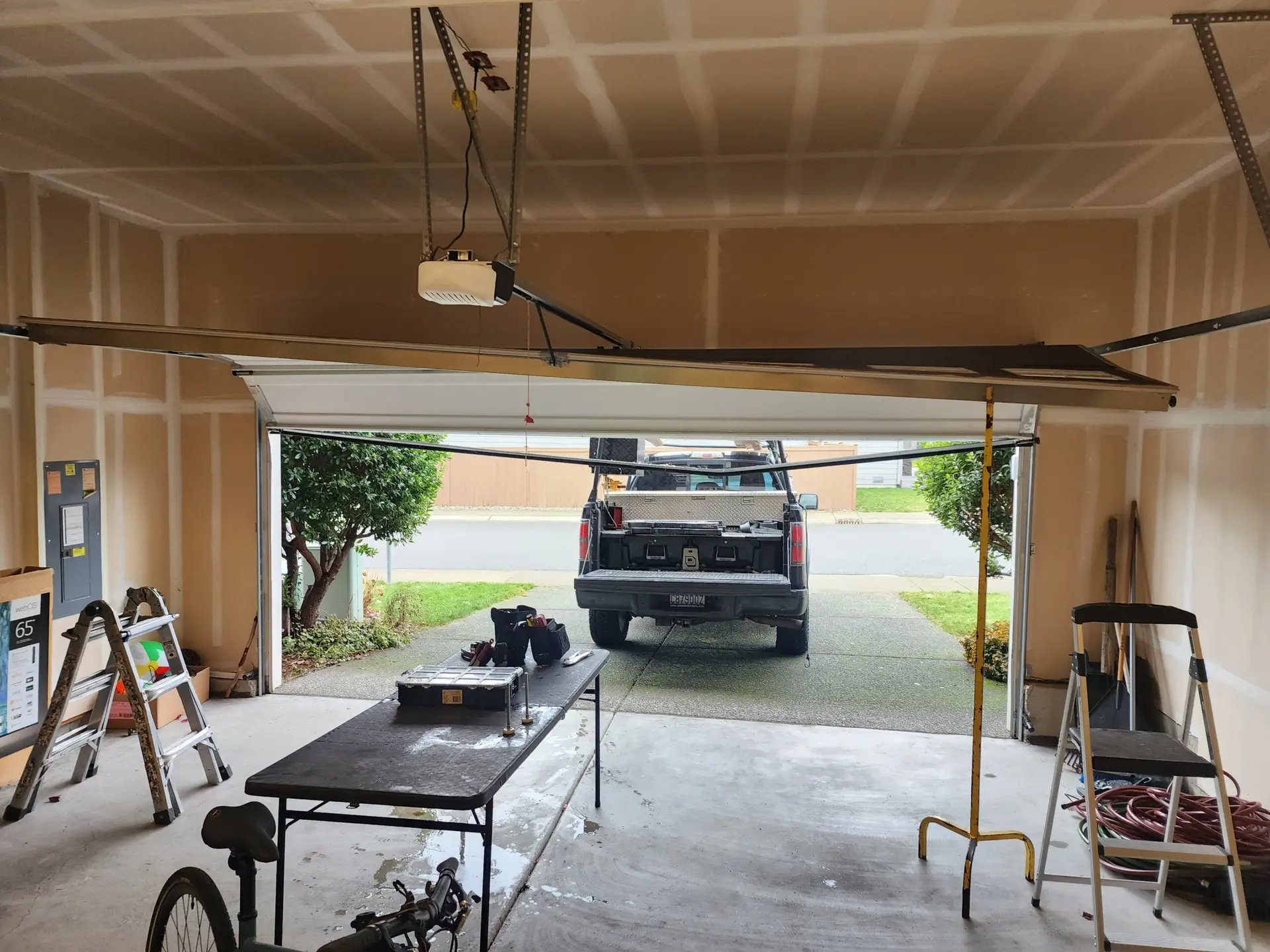 Open garage with truck outside and repair tools inside