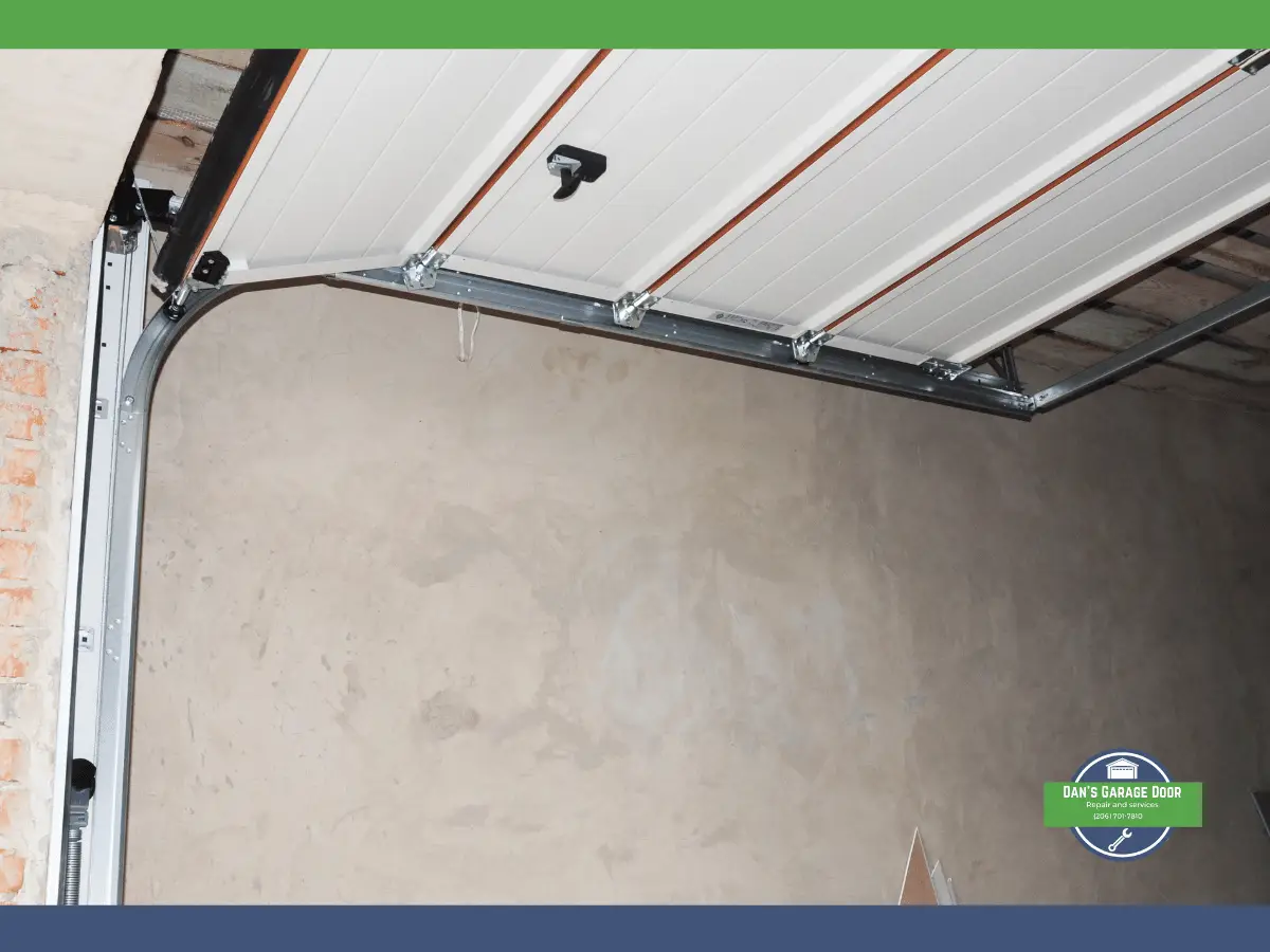Open garage door showing track, ceiling panels, and wall