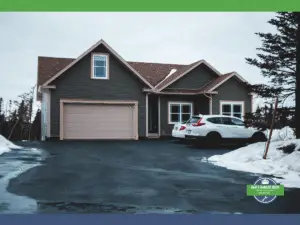 Winterized home with garage door and a car parked outside, surrounded by snow.