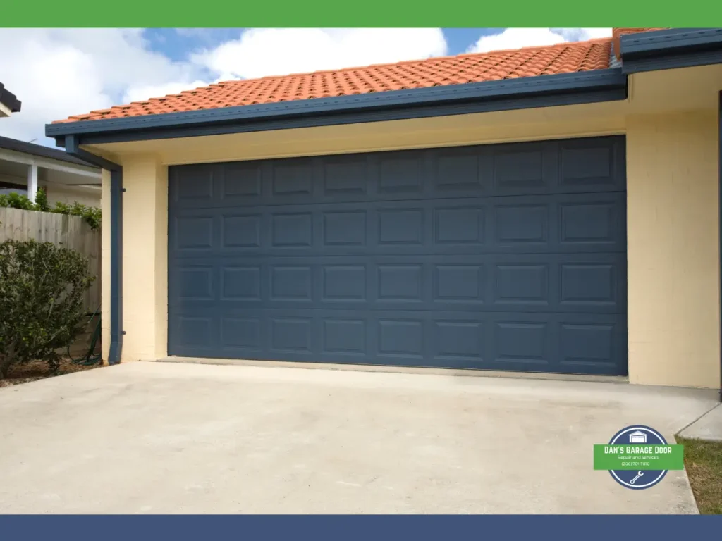 Blue garage door on a house with a terracotta tile roof.