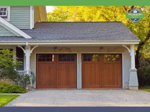 Two wooden garage doors with rectangular panels, set in a house facade.