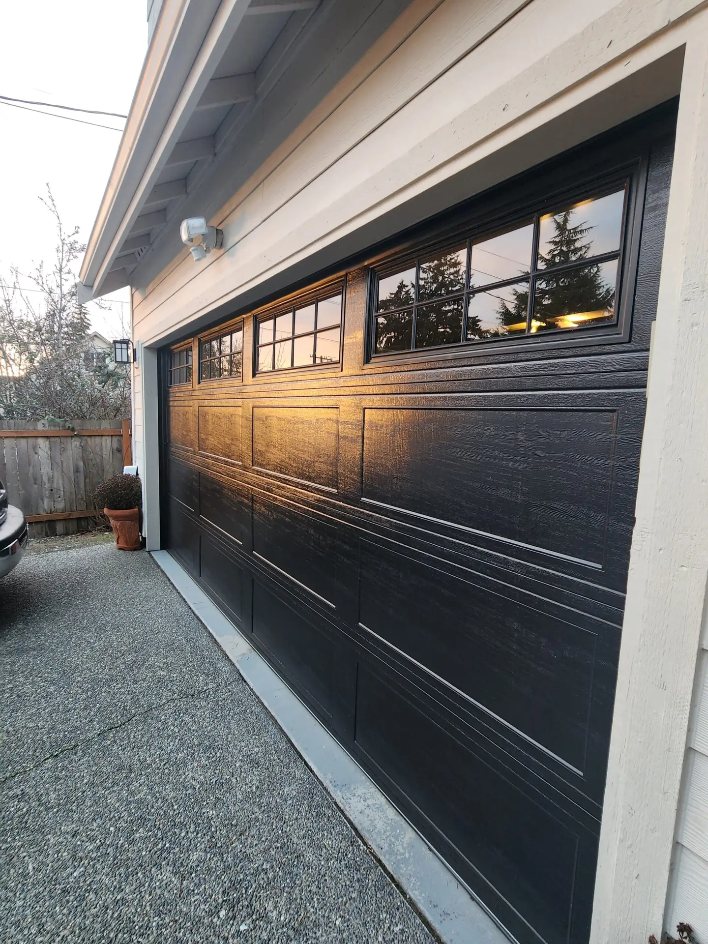 Black garage door with upper window panels