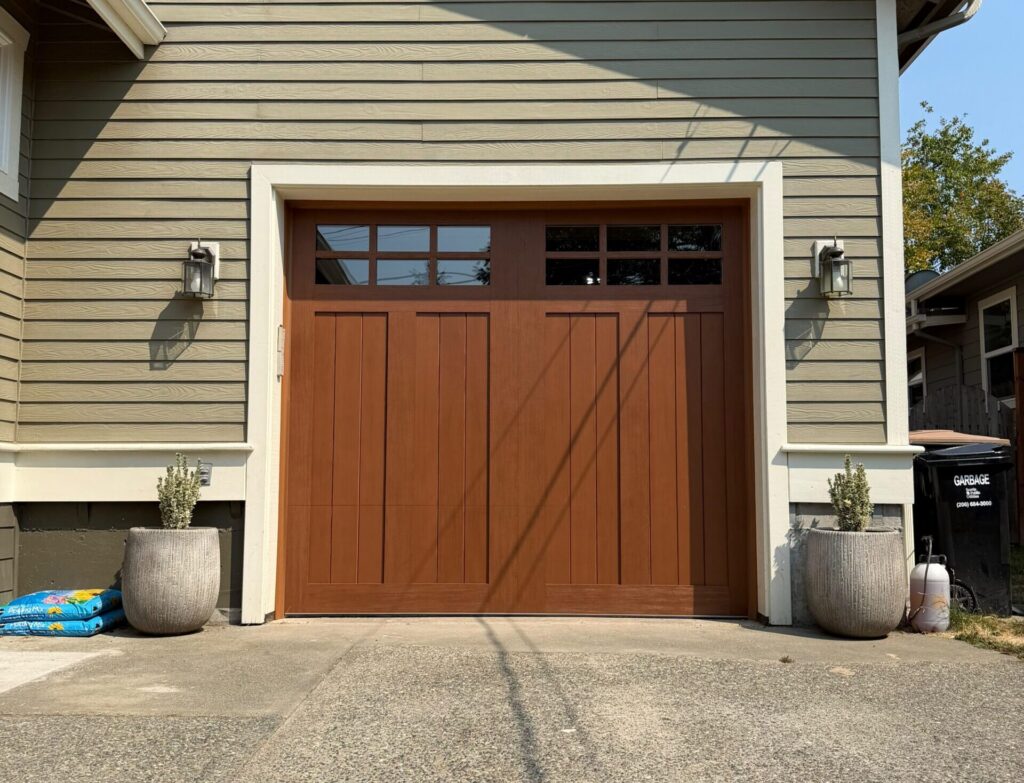 Brown wooden garage door with upper window panels