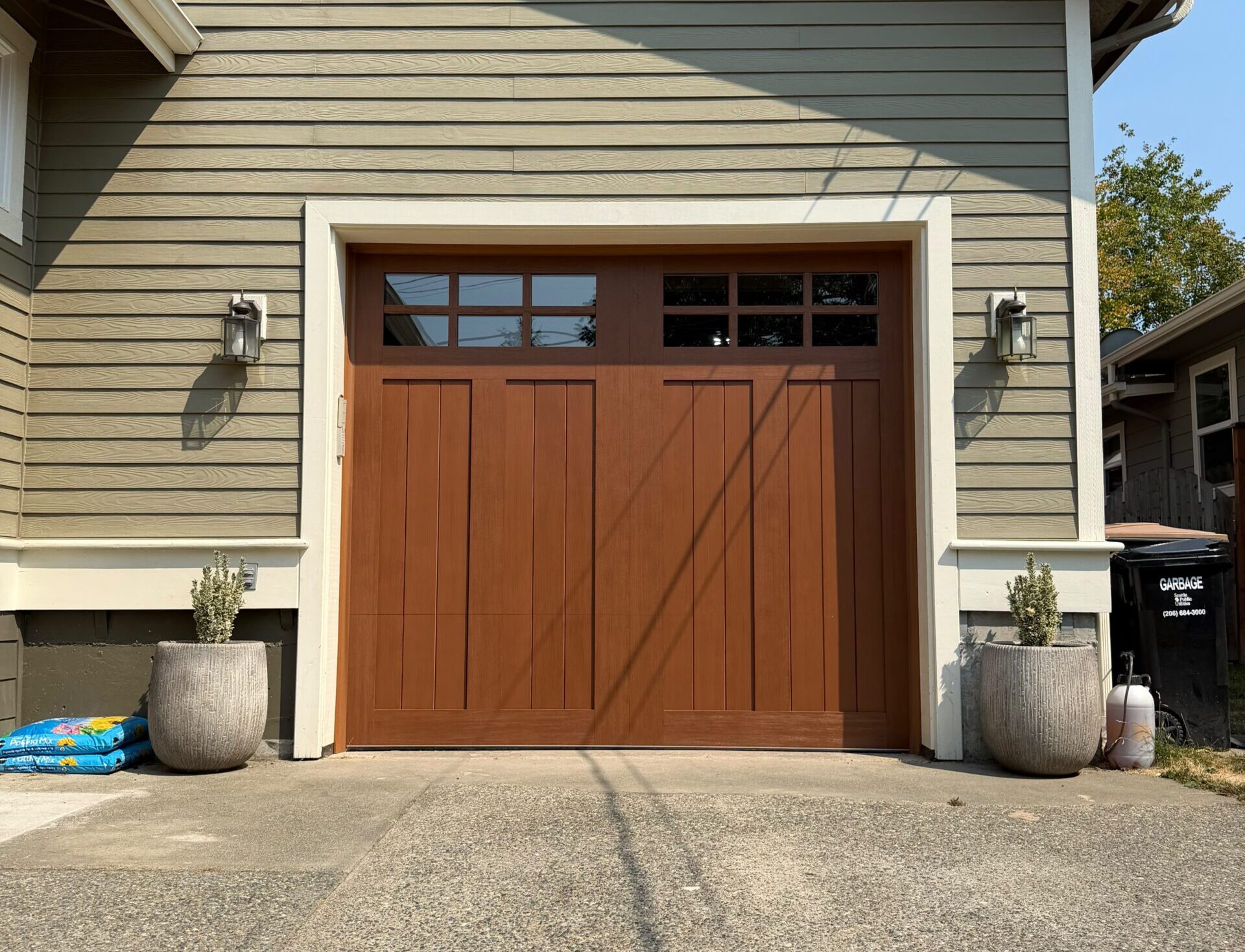Brown wooden garage door with upper window panels