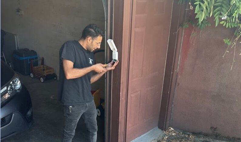 Man inspecting a wall-mounted