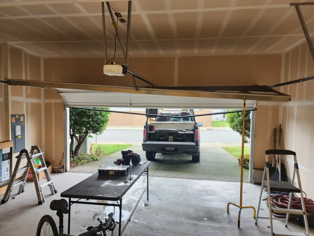 Open garage with truck outside and repair tools inside