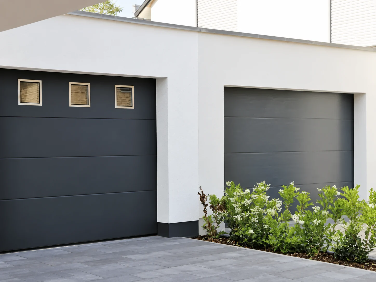 Two black garage doors, one with three square windows