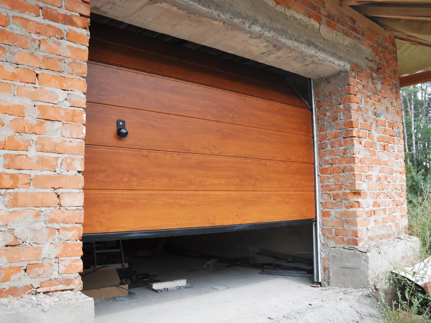 Open garage door showing track, ceiling panels, and wall
