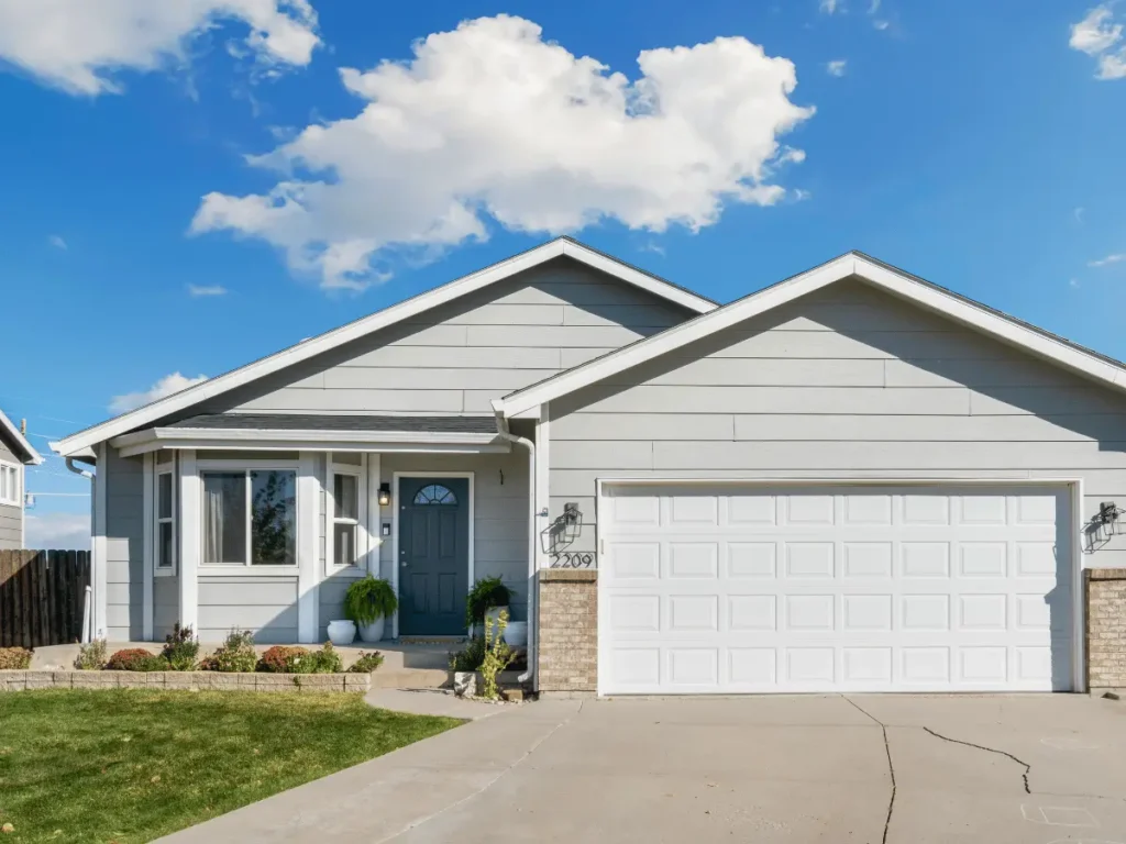 Suburban house with white garage door and blue front door