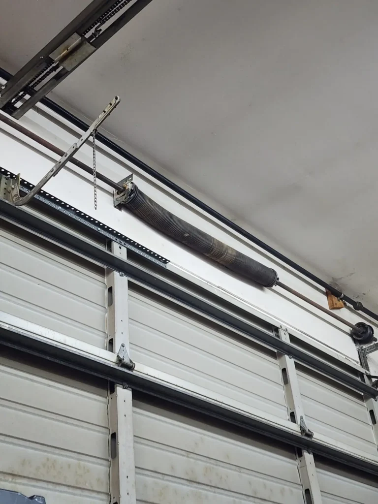 Garage door torsion spring and metal track mechanism